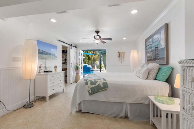 tiled bedroom with ceiling fan, ornamental molding, a barn door, and access to exterior