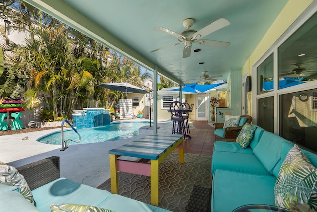 view of swimming pool with pool water feature, a patio area, an outbuilding, ceiling fan, and an outdoor living space