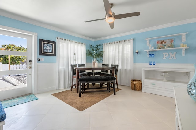 tiled dining area with crown molding and ceiling fan