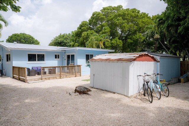 768 Musa Dr, Key Largo, FL 33037 - view of front facade featuring a storage unit, a deck, and a metal roof
