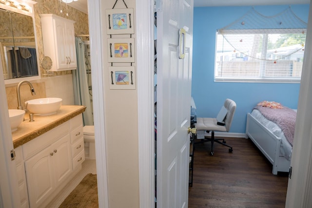 768 Musa Dr, Key Largo, FL 33037 - bedroom with dark wood-type flooring and connected bathroom