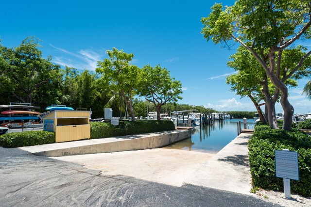 exterior space with a dock and a water view