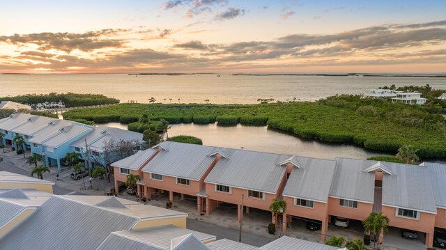 aerial view at dusk with a water view