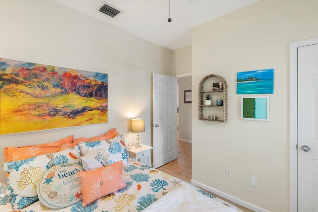 bedroom featuring light tile patterned floors, baseboards, and visible vents