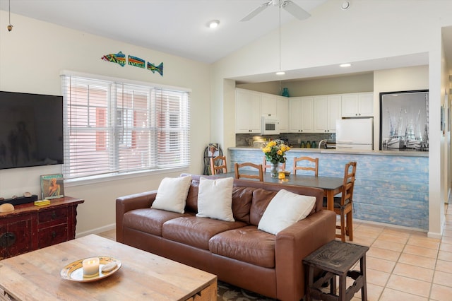 living area with light tile patterned floors, lofted ceiling, recessed lighting, a ceiling fan, and baseboards