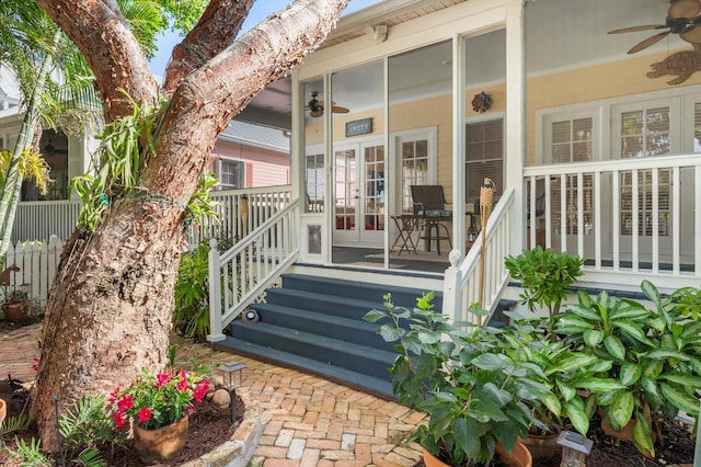 view of exterior entry featuring a ceiling fan and french doors