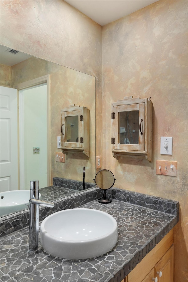 bathroom featuring visible vents and vanity