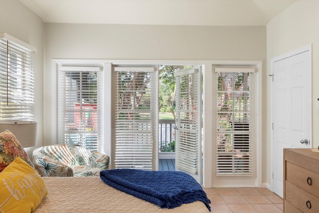 bedroom with access to outside and light tile patterned flooring