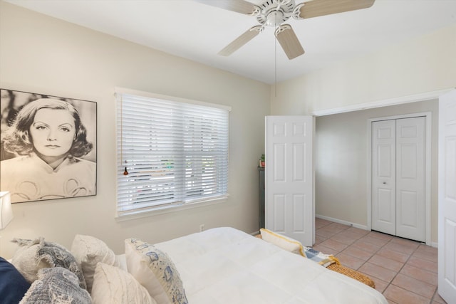 bedroom featuring light tile patterned flooring, ceiling fan, and baseboards