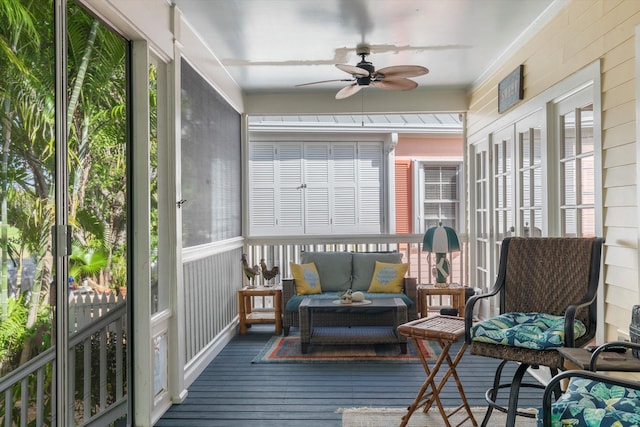 sunroom / solarium with a ceiling fan