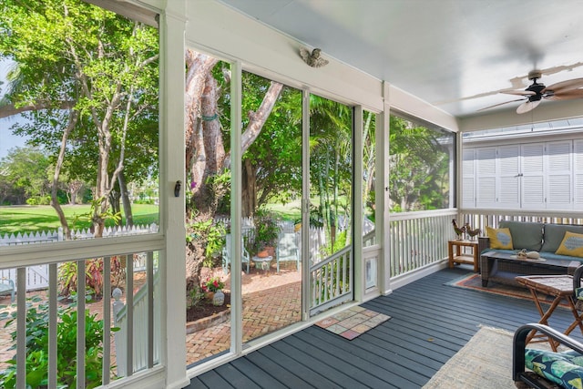 sunroom / solarium featuring ceiling fan and a wealth of natural light