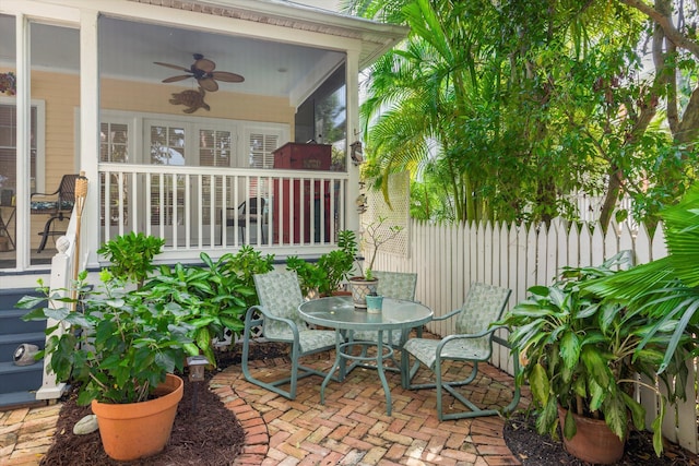 view of patio / terrace with ceiling fan and fence