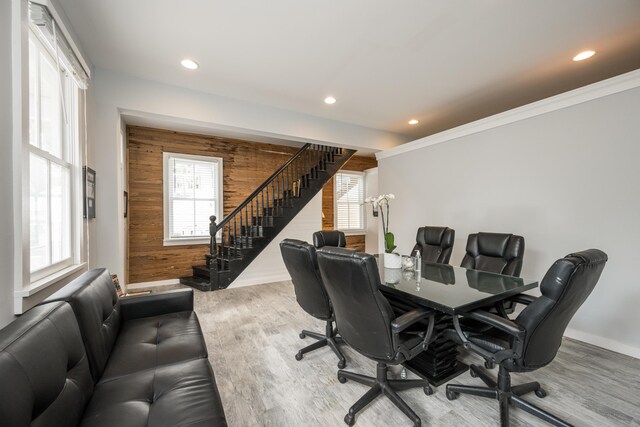 office with hardwood / wood-style flooring, ornamental molding, and wood walls