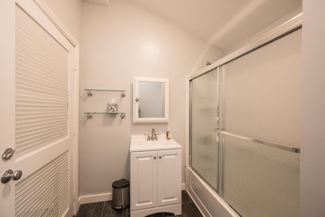 bathroom featuring vanity, combined bath / shower with glass door, and hardwood / wood-style floors