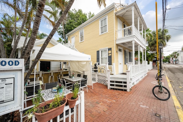 view of front of property featuring a patio area and a balcony