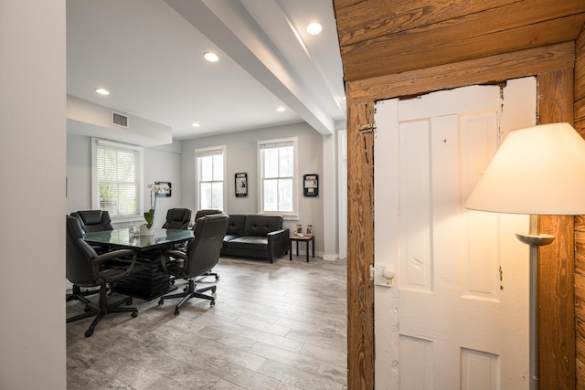 interior space featuring beamed ceiling and hardwood / wood-style floors