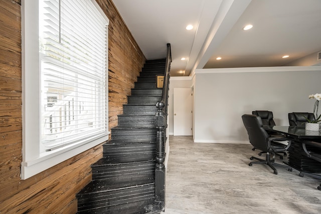 home office with crown molding, hardwood / wood-style flooring, and wooden walls