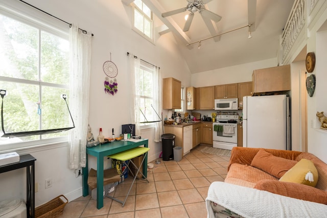 kitchen featuring light tile patterned floors, white appliances, ceiling fan, track lighting, and vaulted ceiling