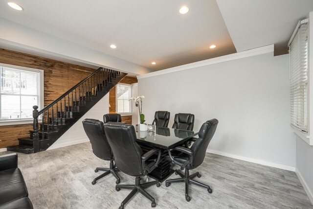 office area featuring crown molding, hardwood / wood-style floors, and wood walls