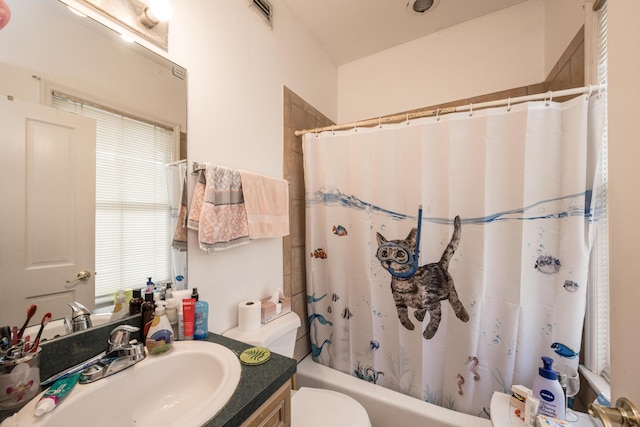 full bathroom with vanity, toilet, and shower / tub combo