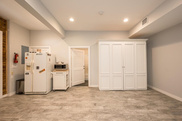 interior space featuring white cabinetry, light hardwood / wood-style floors, and white fridge with ice dispenser