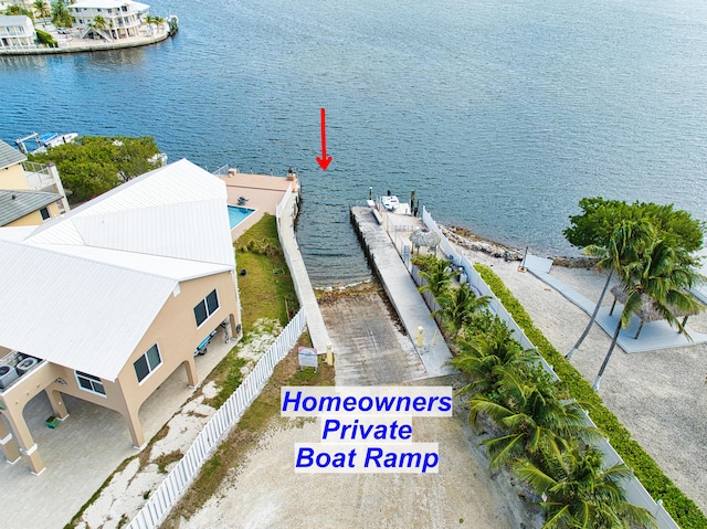 exterior space with fence and a water view