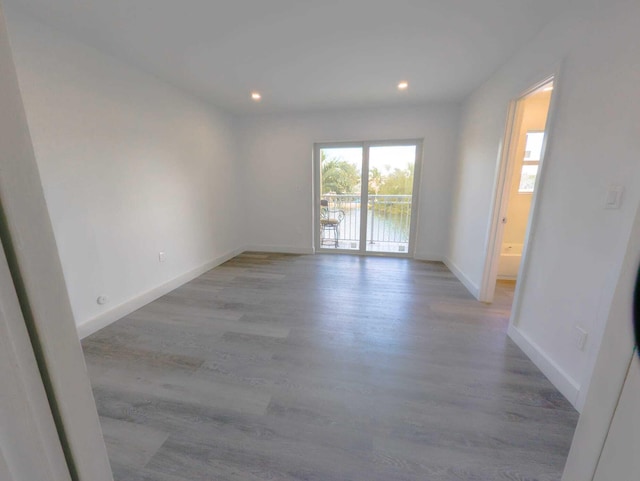 unfurnished room with light hardwood / wood-style floors