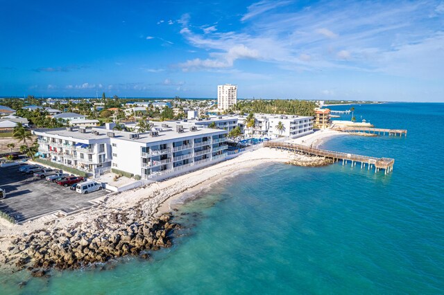 birds eye view of property featuring a beach view and a water view