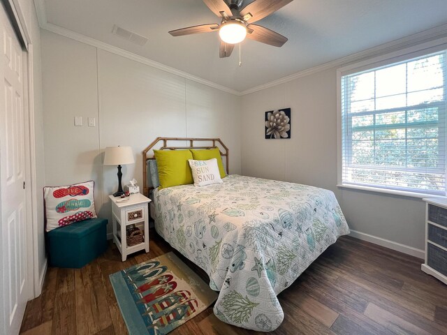 bedroom with ornamental molding, dark wood finished floors, baseboards, and ceiling fan