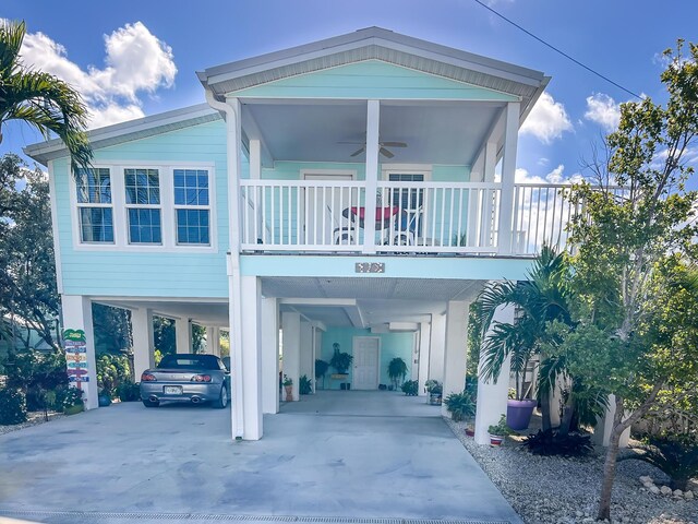 view of front facade with a carport, a ceiling fan, and concrete driveway