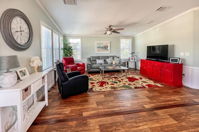 living area featuring visible vents, dark wood finished floors, and a textured ceiling