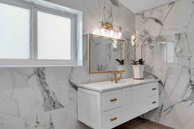 bathroom with vanity and tile walls