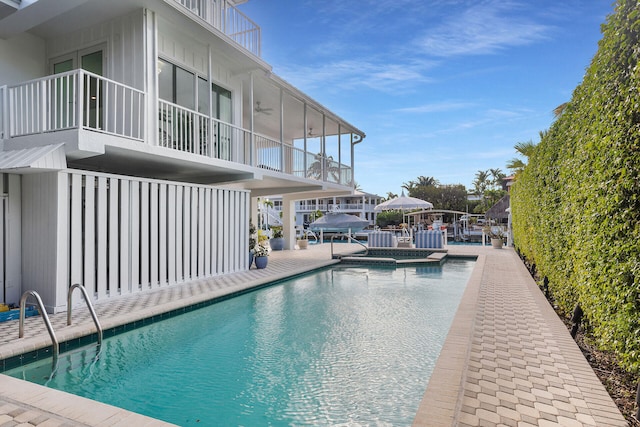 view of swimming pool with ceiling fan