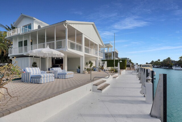 back of property with a water view