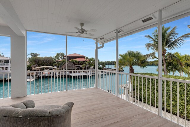 living room with lofted ceiling, light hardwood / wood-style flooring, wooden ceiling, and a water view