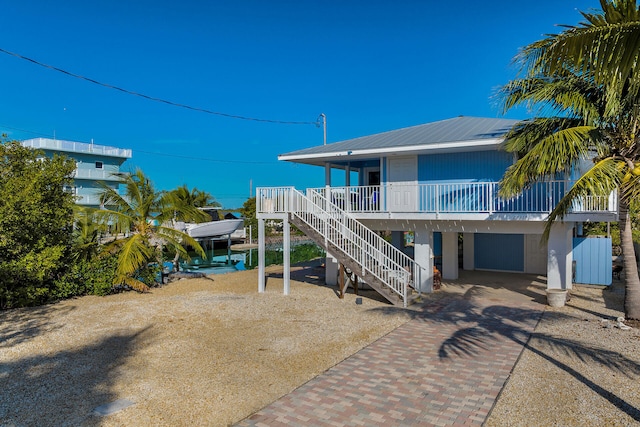 rear view of house with a carport and covered porch