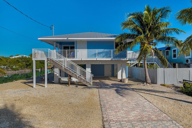 back of property featuring a carport and a porch