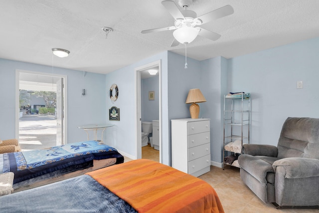 tiled bedroom featuring ceiling fan and a textured ceiling