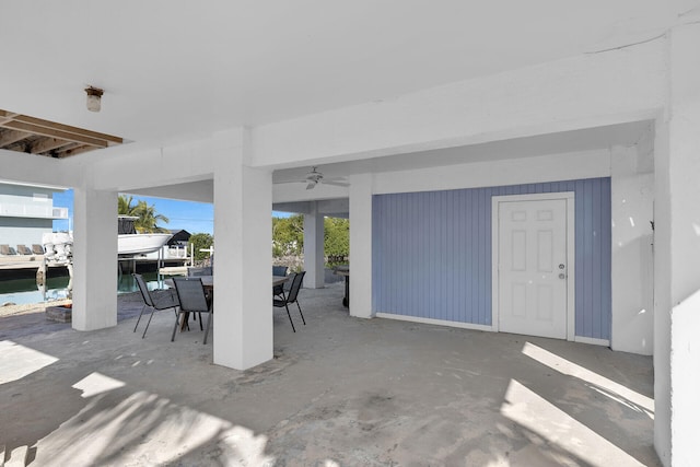 view of patio / terrace with ceiling fan and a water view