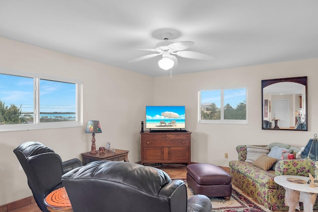 living room with plenty of natural light, ceiling fan, and light tile patterned flooring