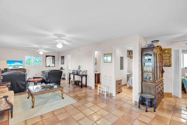 tiled living room with electric panel and ceiling fan