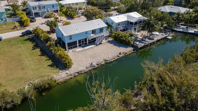 drone / aerial view featuring a residential view and a water view