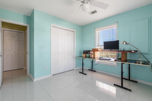 office featuring visible vents, baseboards, light tile patterned flooring, and a ceiling fan