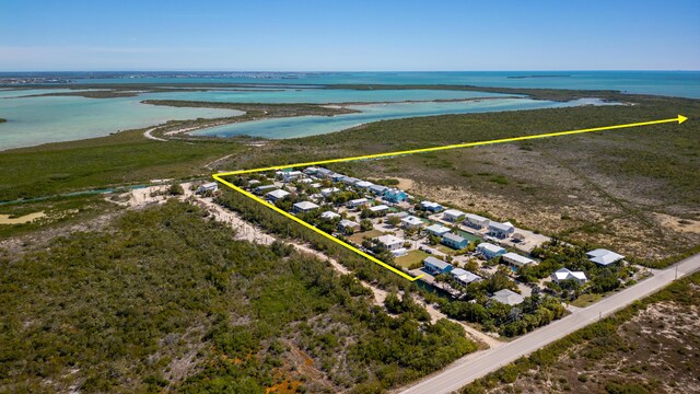 coastal home with a fenced front yard, an attached garage, decorative driveway, and a carport