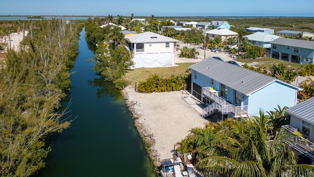 drone / aerial view featuring a residential view and a water view