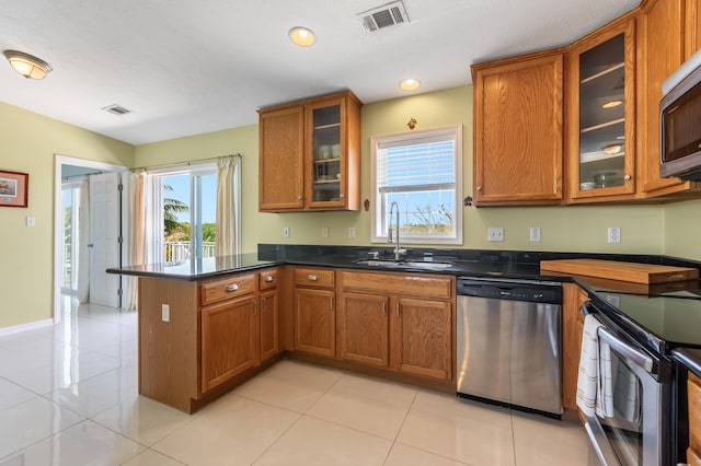 kitchen featuring brown cabinetry, visible vents, and stainless steel appliances