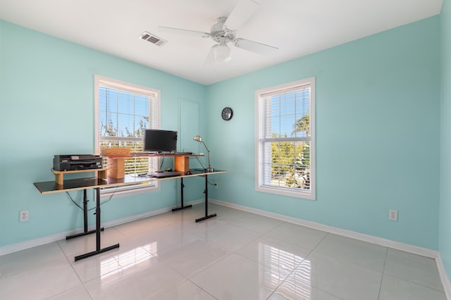 office featuring tile patterned floors, baseboards, visible vents, and ceiling fan