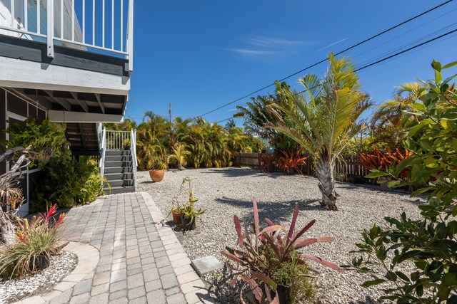 view of yard featuring stairway and fence