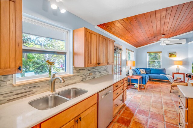 kitchen featuring sink, tasteful backsplash, dishwasher, a wall unit AC, and ceiling fan