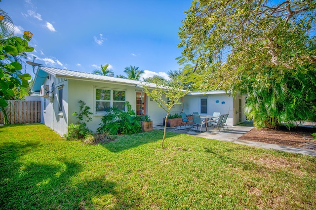 view of front of home with a patio and a front lawn